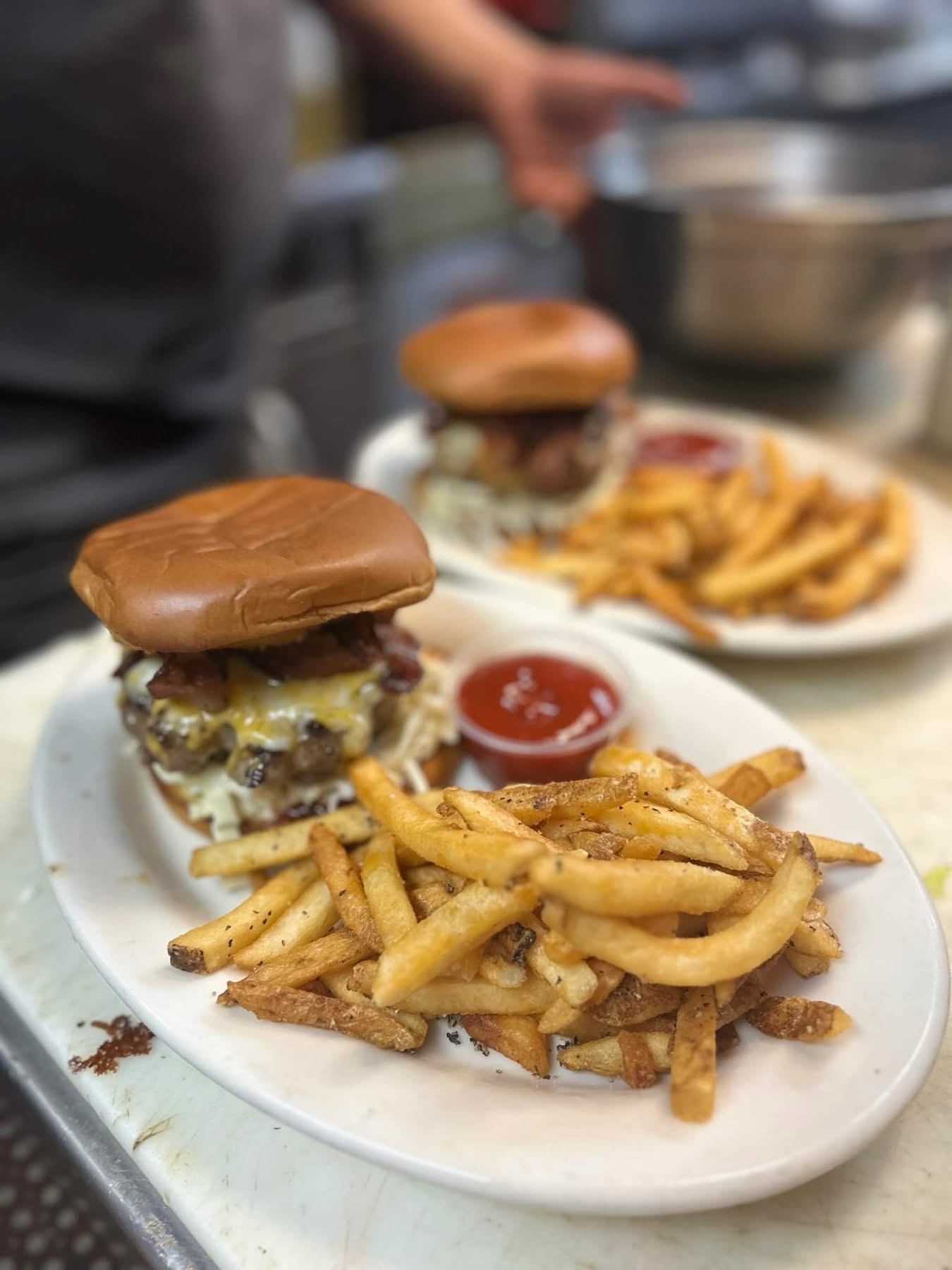 Fresh burgers and fries plated in the Bar N9NE kitchen