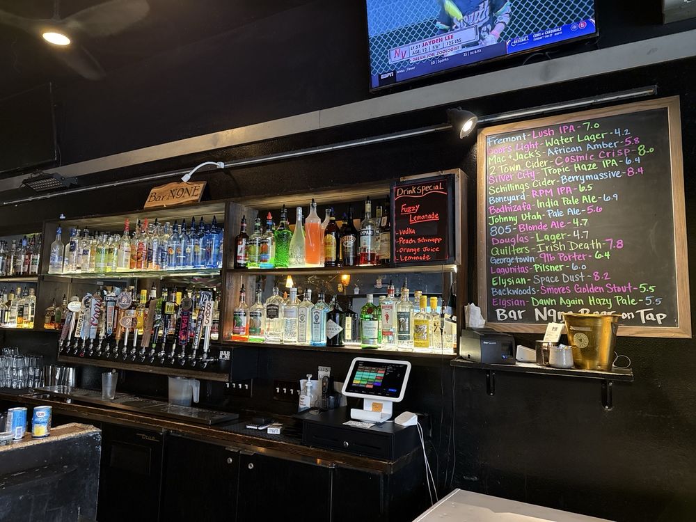 Inside Bar N9NE — the bar counter with taps and the Bar N9NE wood sign